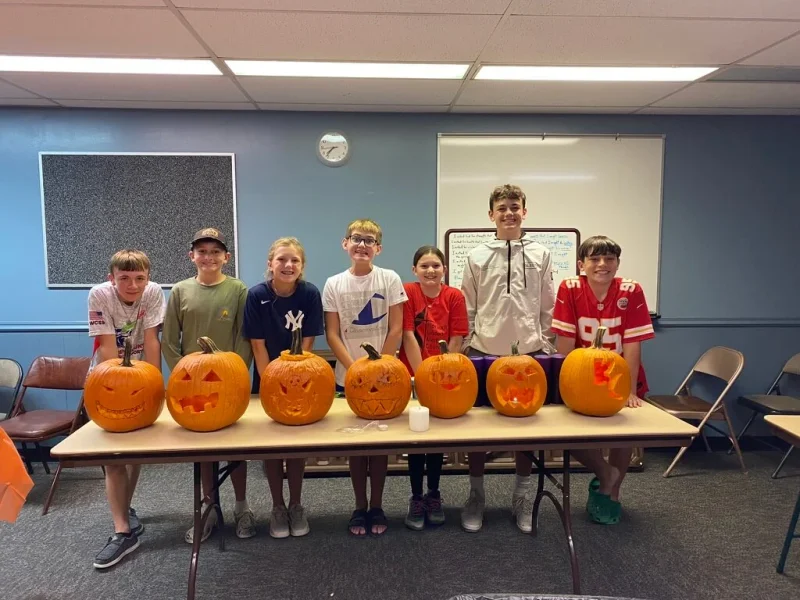 Students carving pumpkins